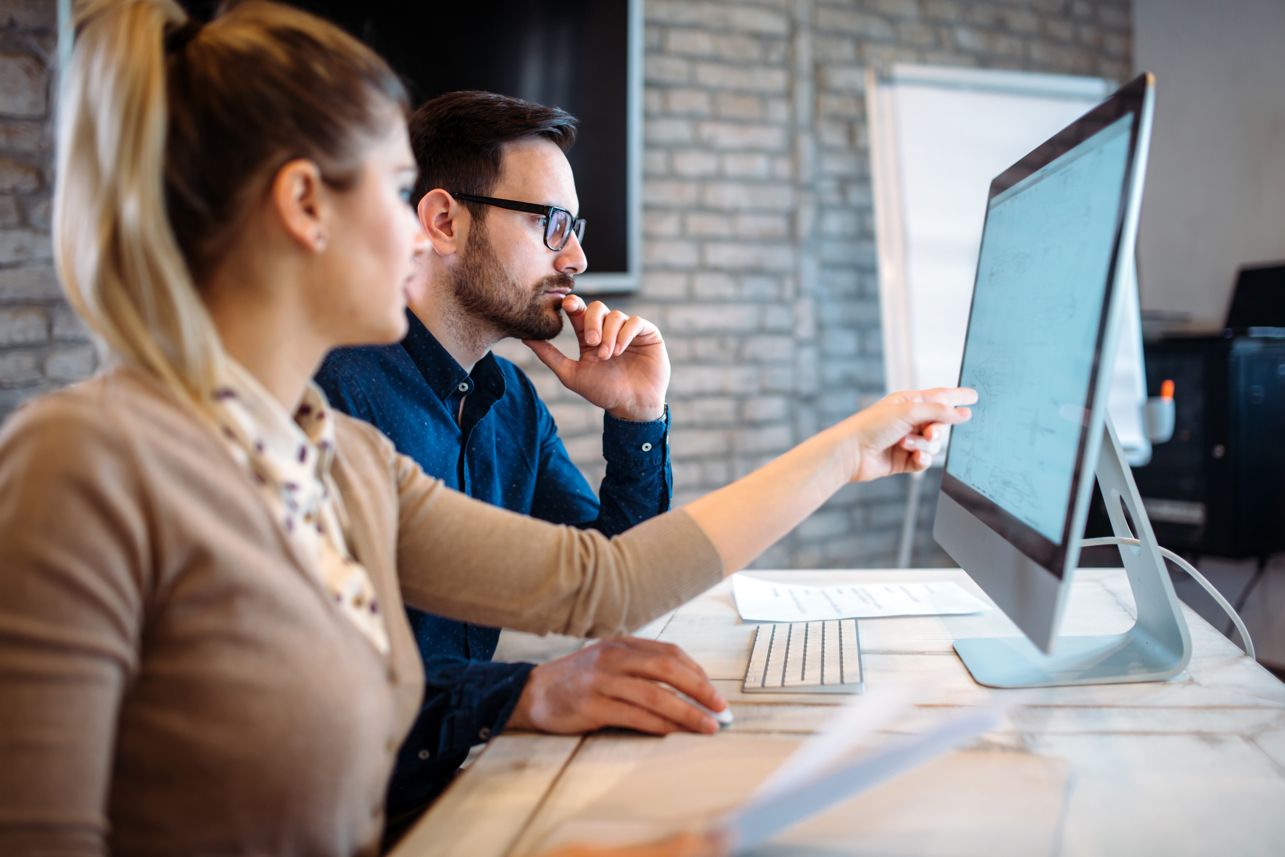 Two people looking at laptop