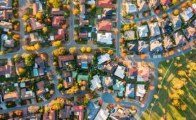 Suburban houses and streets as seen from overhead.