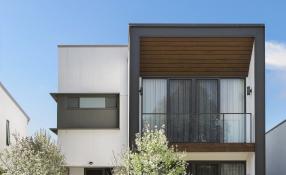 Image of a modern residential building with blue sky in background