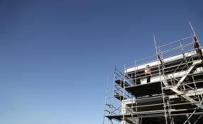 Image of building scaffolding and clear blue sky background