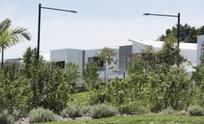 This is an image of a townhouse surrounded with green trees and nature