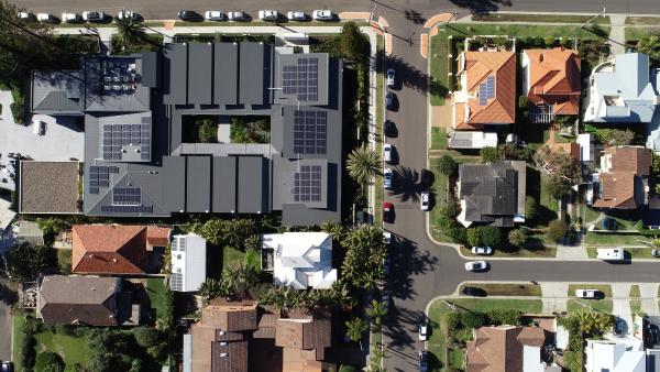 Ariel view street and houses with solar panelling