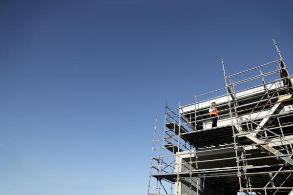 Image of building scaffolding and clear blue sky background