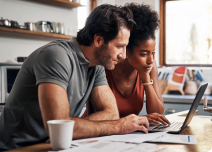 A couple planning their project home on their laptop.