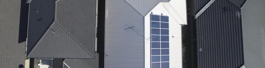 Aerial shot of a residential building with colourbond roofing and solar panels