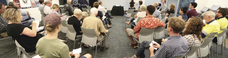 Image of community members watching a presentation