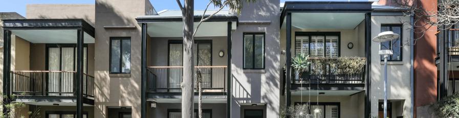 Image of residential building on tree lined street