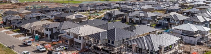 Image of a newly built housing estate with brown and grey roofs
