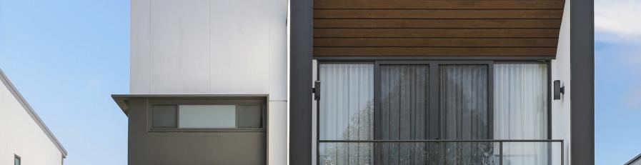 Image of a modern residential building with blue sky in background