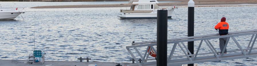 man fishing on wharf