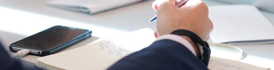 This is an image of a man filling out paperwork